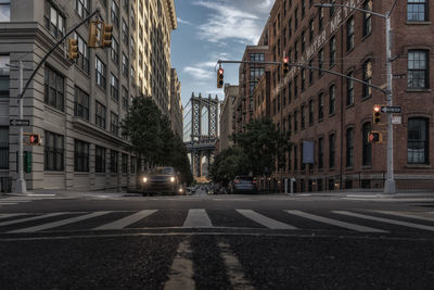 Manhattan bridge seen through buildings in city