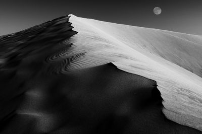 Close-up of sand dune in desert against sky