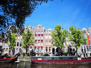 VIEW OF RIVER WITH BUILDINGS IN BACKGROUND