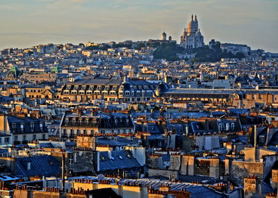 Distant view of basilique du sacre coeur with cityscape in foreground