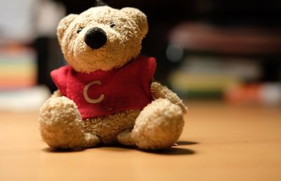 Close-up of teddy bear on wooden table