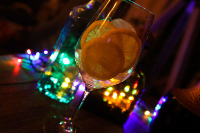 Close-up of illuminated candles on glass table