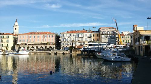 Boats in harbor with buildings in background