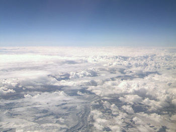 Aerial view of clouds over landscape against sky