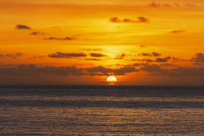 Scenic view of sea against romantic sky at sunset