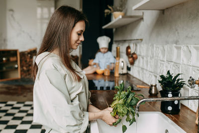 Young woman holding food at home