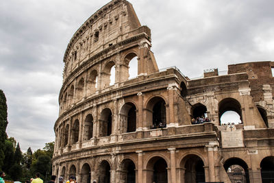 Low angle view of historical building against cloudy sky