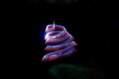 Close-up of illuminated lights over black background