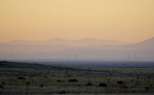 Scenic view of field against sky during sunset