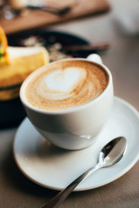 Close-up of cappuccino on table