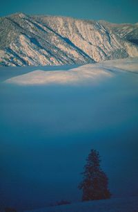 Scenic view of mountains against cloudy sky