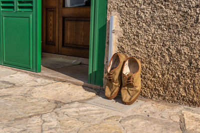 Shoes by door against wall