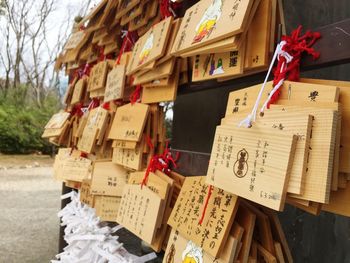 Wishes tied to nails on wooden plank