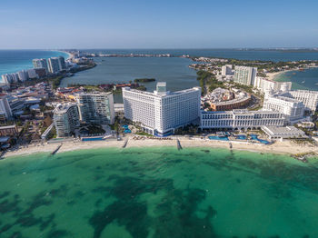 High angle view of buildings by sea against sky