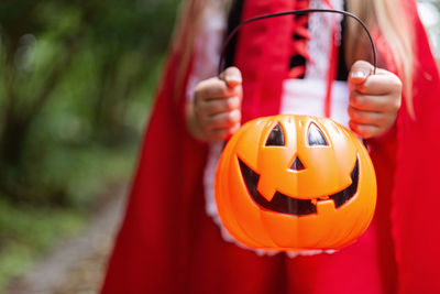 Little girl in costume of red hat in the park. happy halloween concept. high quality photo