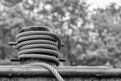 Close-up of rope tied to wooden post