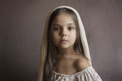 A girl with her hair down and a handkerchief on her head