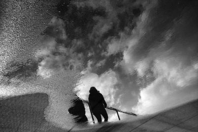 Reflected rear view of people walking outdoors