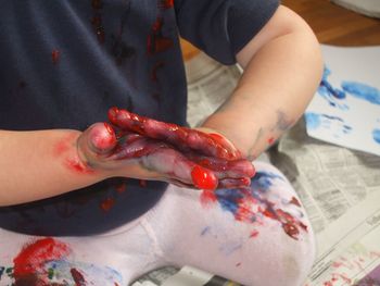 High angle view of baby holding hands
