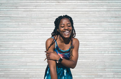Laughing african american female in sportswear standing after fitness practice