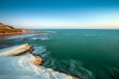 Scenic view of sea against clear blue sky