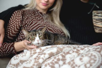 Midsection of woman with cat