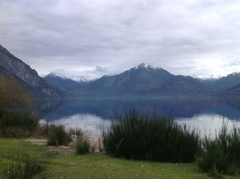 Scenic view of lake and mountains against sky