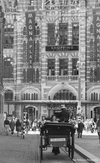 People on street against buildings in city