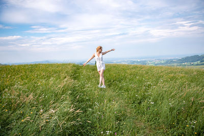 Full length of person standing on field against sky