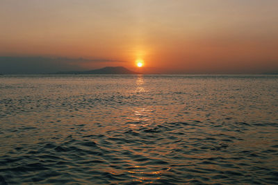 Scenic view of sea against romantic sky at sunset