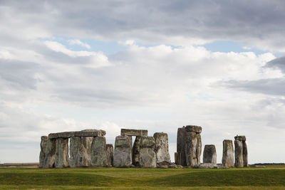 Rock formations on field against sky