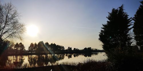 Scenic view of lake against clear sky during sunset