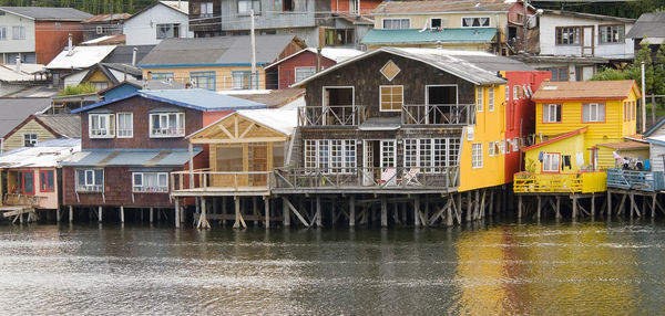 Buildings by river in city