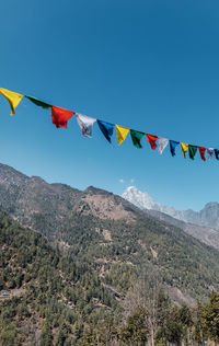 Low angle view of flags against sky