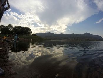 Scenic view of lake against cloudy sky