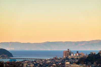 City by sea against clear sky in the morning sunlight