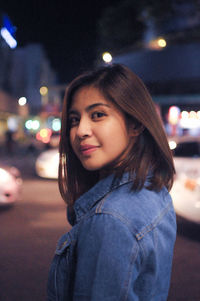 Portrait of young woman at night