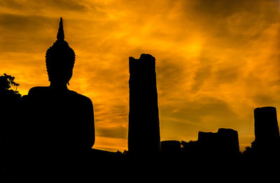 Low angle view of silhouette building against sky during sunset