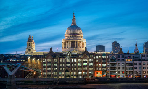 View of buildings in city against sky at dusk