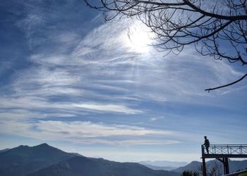 Low angle view of bird on mountain against sky