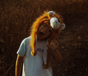 Close-up of girl with toy on field