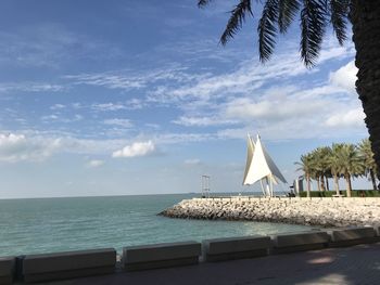 Scenic view of swimming pool by sea against sky