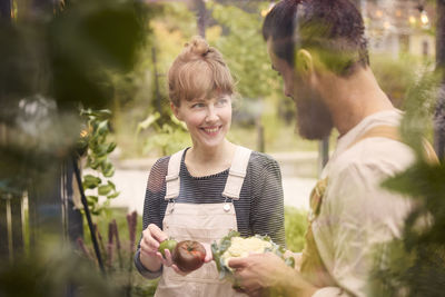 Smiling couple in greenhouse