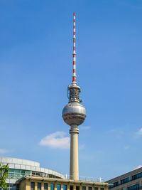 Low angle view of communications tower against sky