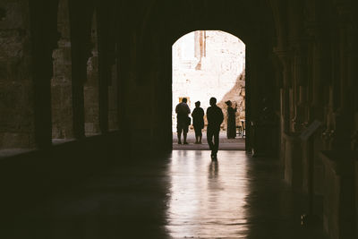 Silhouette people walking in historic building