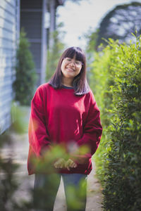 Portrait of a smiling young woman standing outdoors