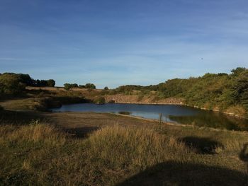 Scenic view of calm lake against sky