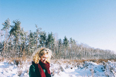 Young woman against sky