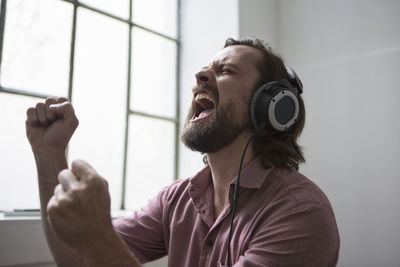 Man with headphones singing to music