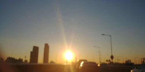 Panoramic view of city buildings against sky during sunset